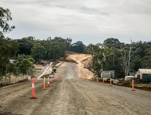 Road grader completing highway surface grading for smooth levels and strong road formation
