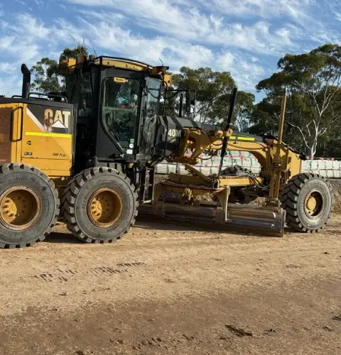 Wet hire motor grader with experienced operator ready for farm and construction grading